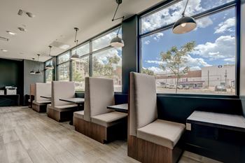 a dining area with chairs and a window view of a street